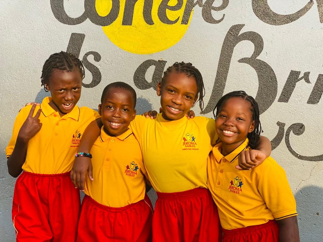 Pupils of Jeroma Smiles smiling in their school uniforms
